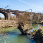 Narrow,River,Under,The,Railway,Bridge,In,Early,Spring,-